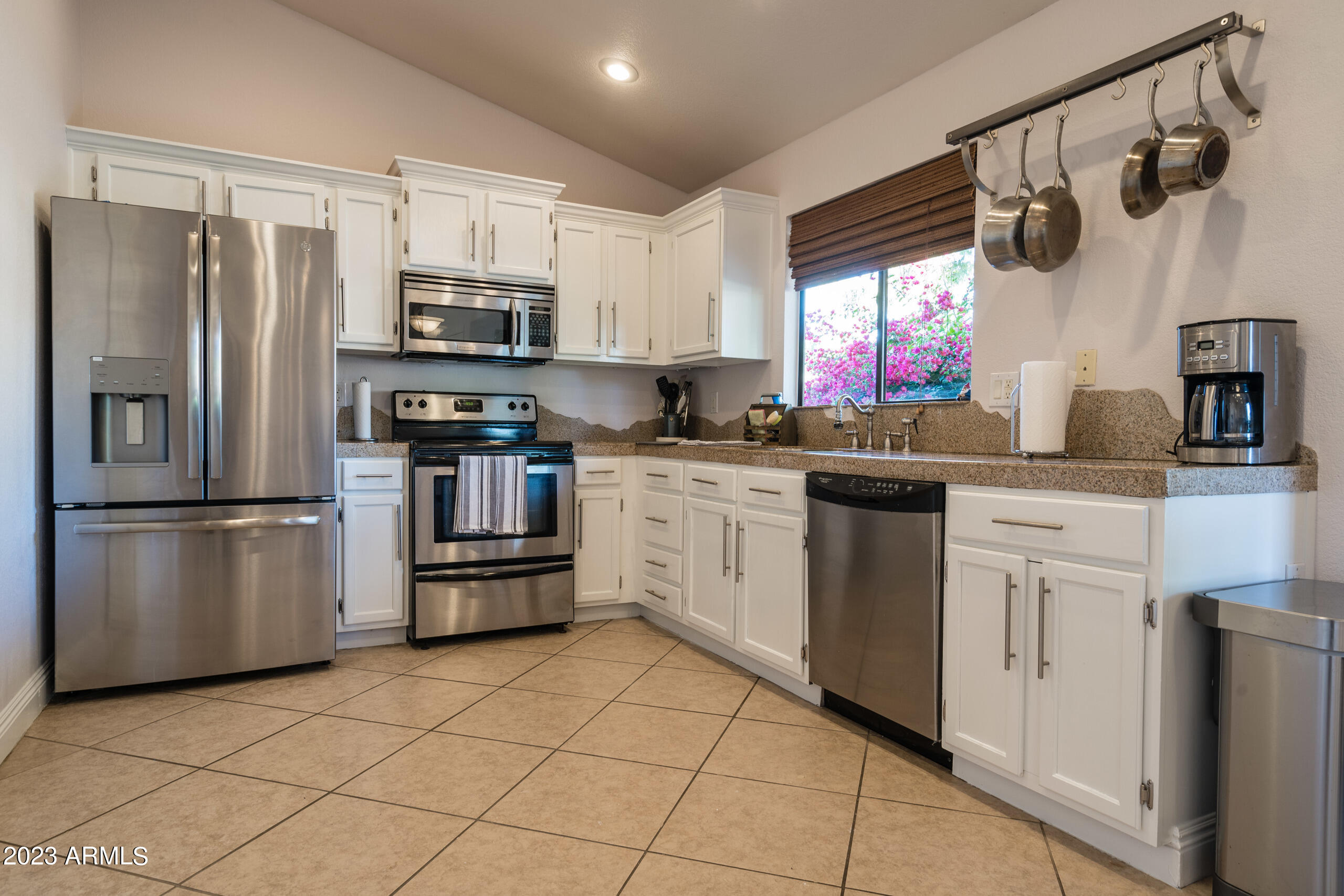 6444 East Sandra Terrace Scottsdale, AZ 85254 - Photo 8 of 22 a kitchen with stainless steel appliances a refrigerator sink and microwave