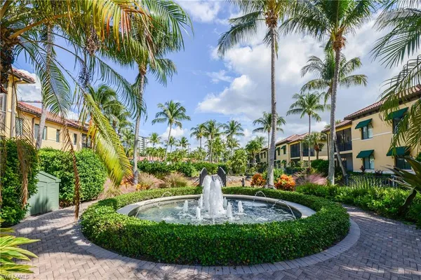 a view of a fountain in front of a house