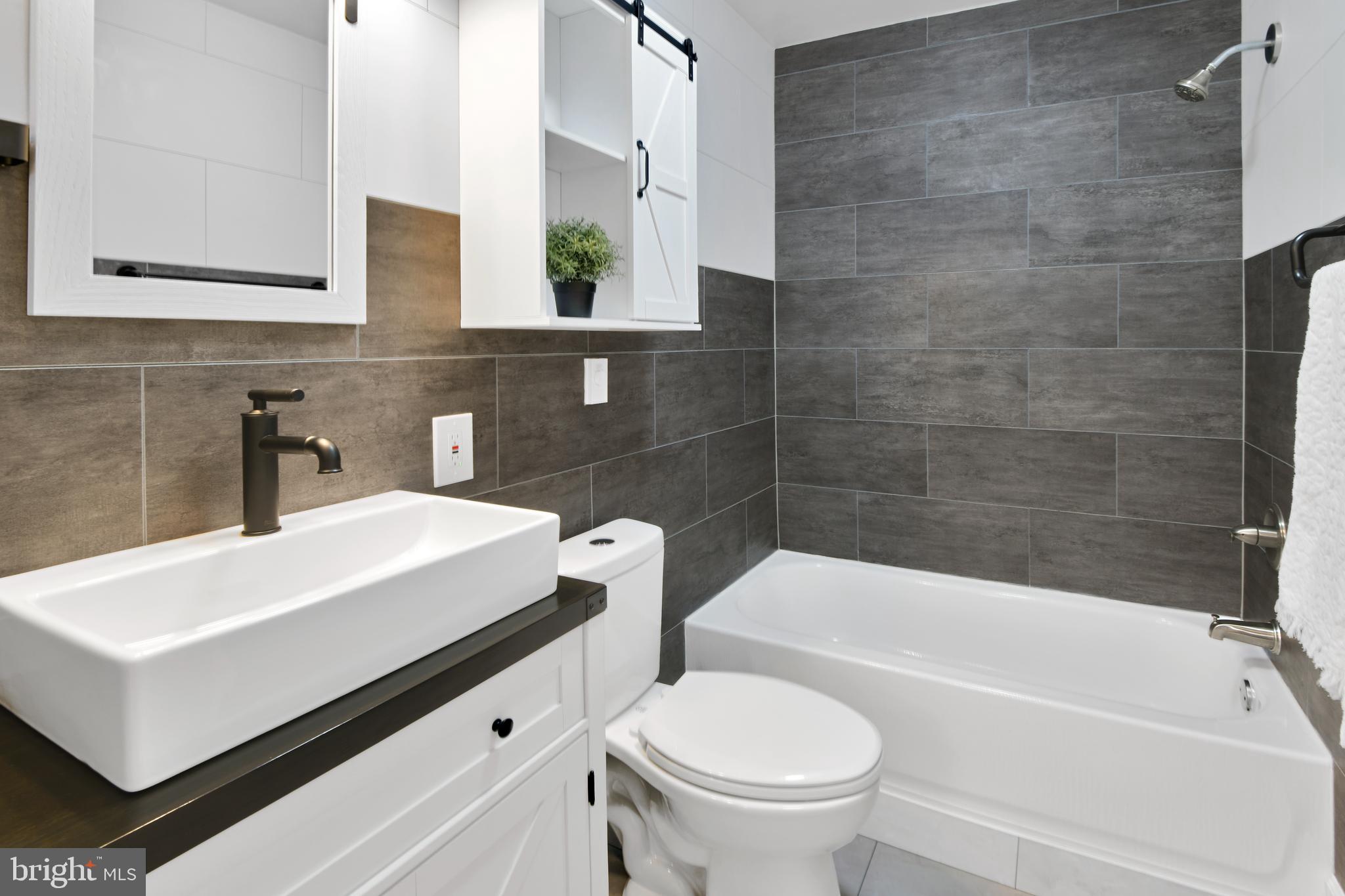 230 East 5th Street Frederick, MD 21701 - Photo 11 of 24 a bathroom with a sink a toilet and bathtub