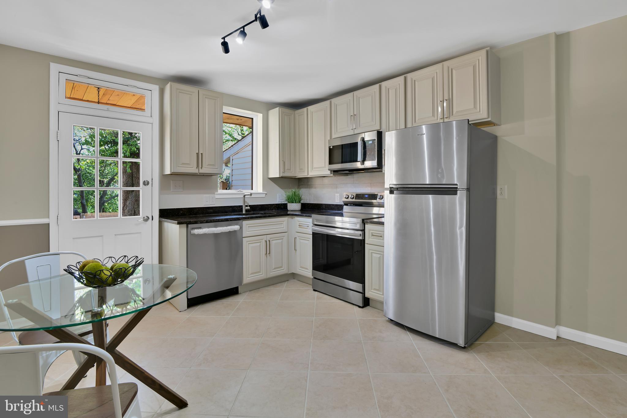 230 East 5th Street Frederick, MD 21701 - Photo 2 of 24 a kitchen with stainless steel appliances a stove a sink refrigerator and a window