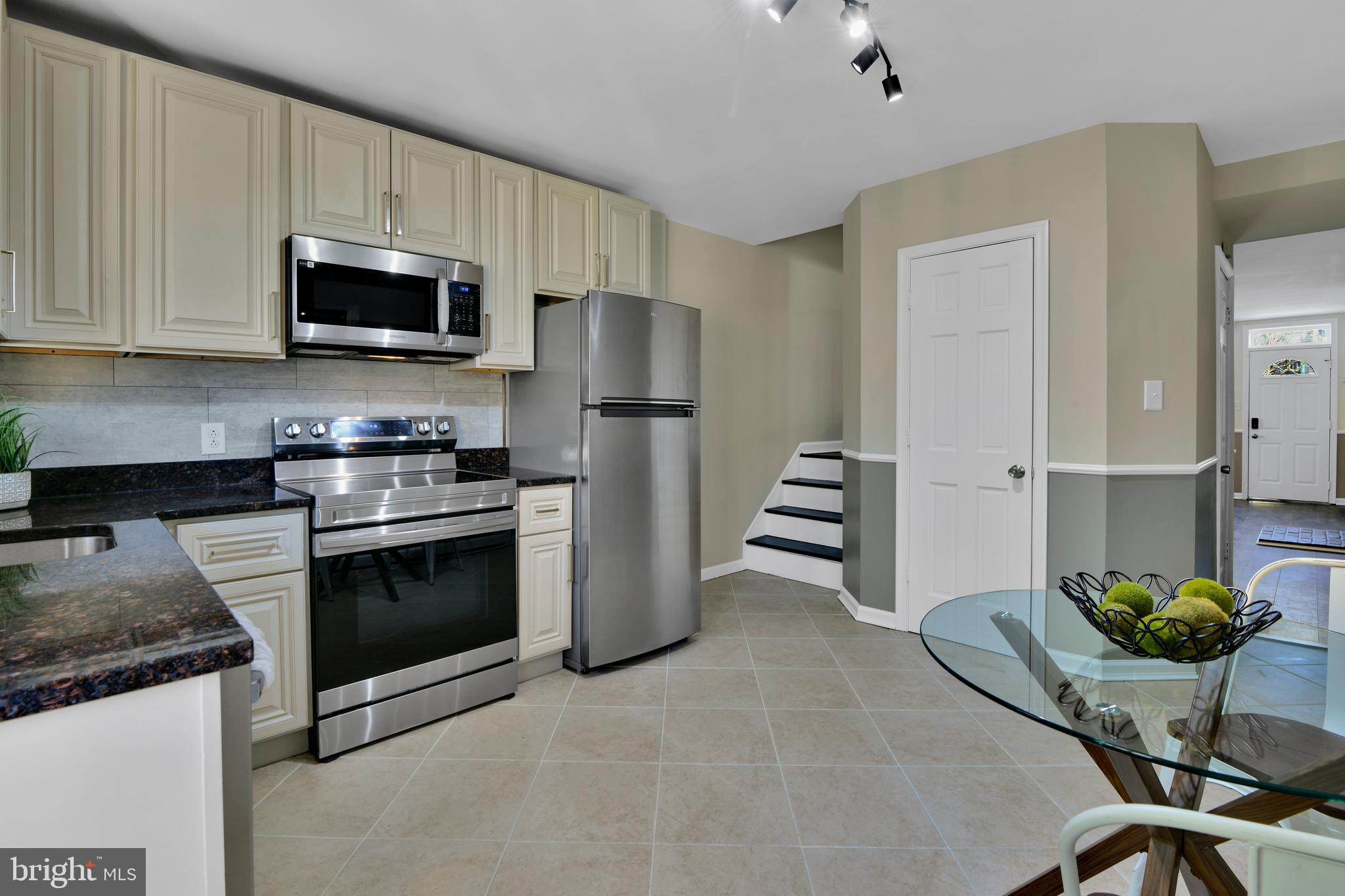 230 East 5th Street Frederick, MD 21701 - Photo 3 of 24 a kitchen with stainless steel appliances granite countertop a stove a refrigerator and a microwave