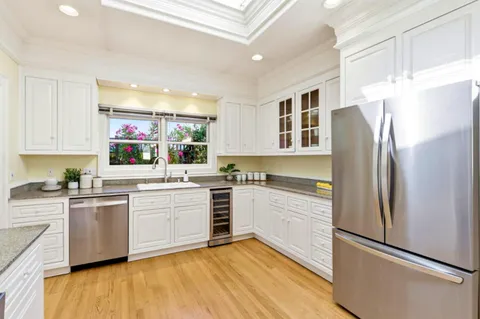 a kitchen with a refrigerator and a sink