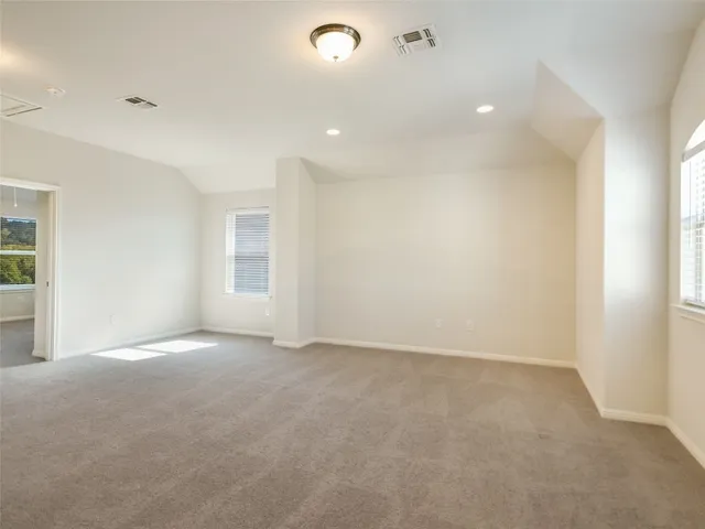 an empty room with windows and entrance