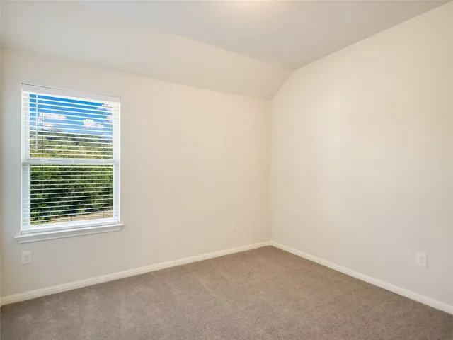 a view of a balcony with a floor to ceiling window next to a yard