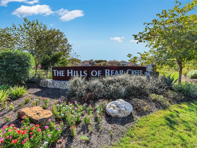 a view of a patio with table and chairs potted plants and large tree