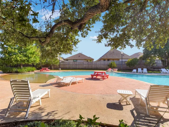 a view of a swimming pool with a yard