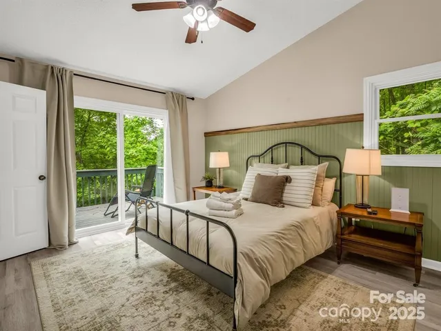 a bedroom with a bed and a large window