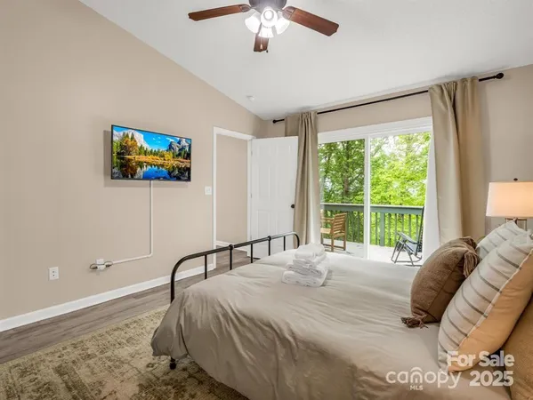 a bedroom with a bed and a flat screen tv