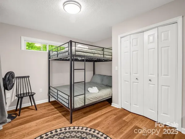 a bedroom with a bunk bed and a window