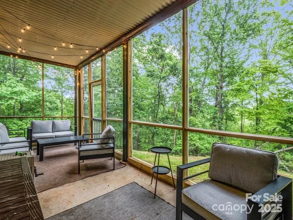 a balcony with furniture and next to a window