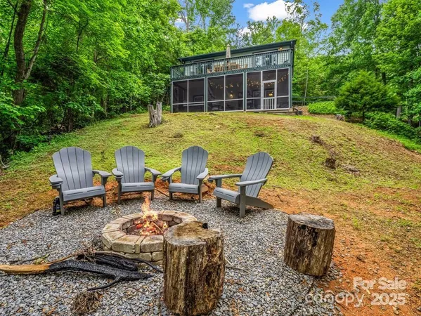 a view of a backyard with table and chairs and couches in the patio