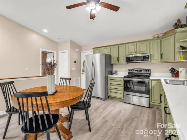 a kitchen with stainless steel appliances kitchen island a stove and a refrigerator
