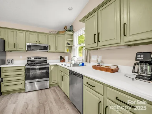 a kitchen with granite countertop a sink and cabinets