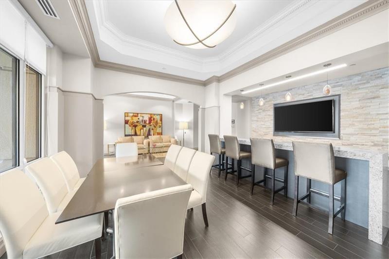 3475 Oak Valley Road Northeast, Unit 410 Atlanta, GA 30326 - Photo 24 of 36 a view of a dining room with furniture wooden floor and chandelier