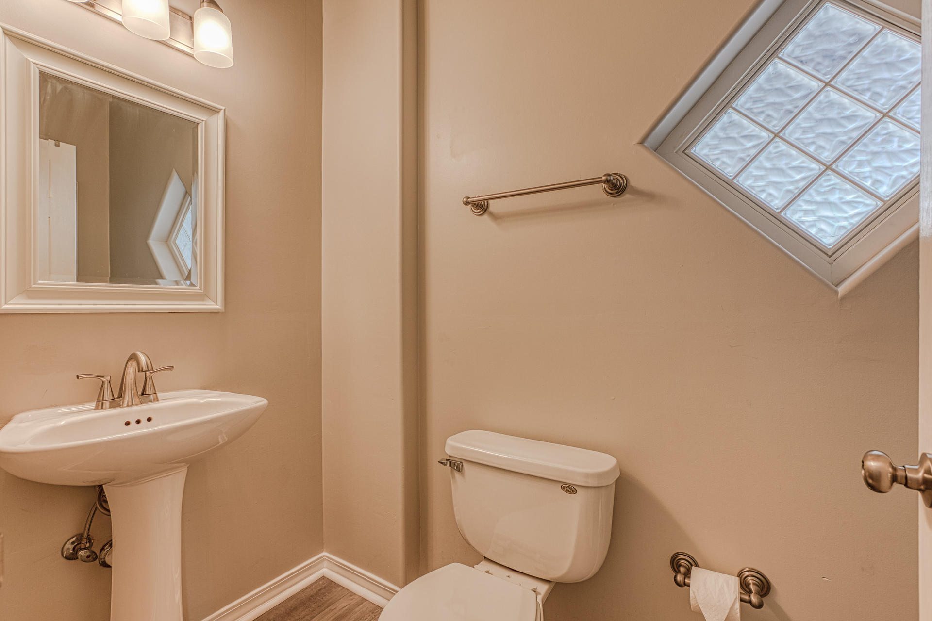 4583 Luke Avenue Destin, FL 32541 - Photo 18 of 86 a bathroom with a toilet sink and mirror