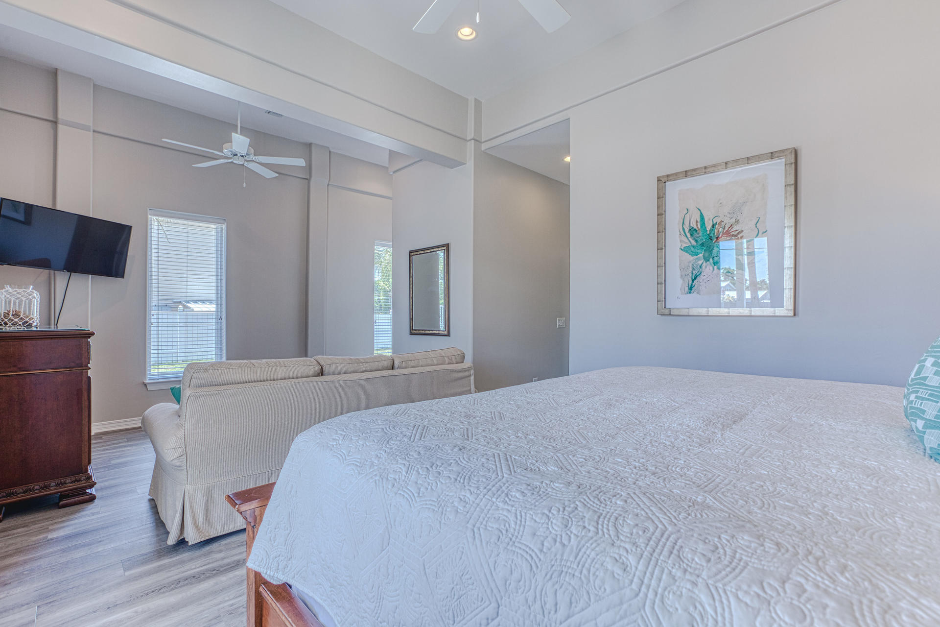 4583 Luke Avenue Destin, FL 32541 - Photo 23 of 86 a spacious bedroom with a bed and a chandelier