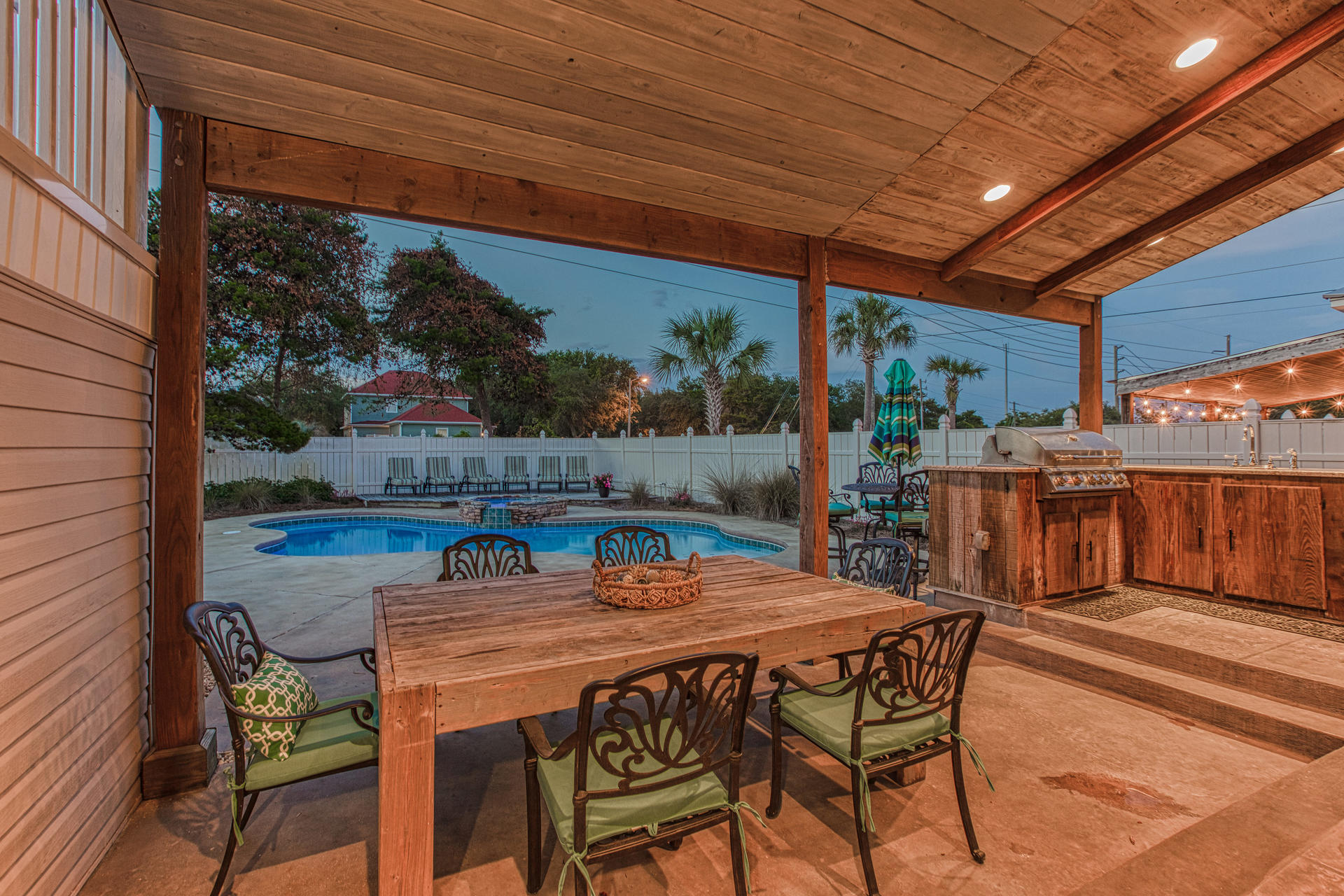 4583 Luke Avenue Destin, FL 32541 - Photo 66 of 86 a view of a patio with table and chairs with wooden floor and plants