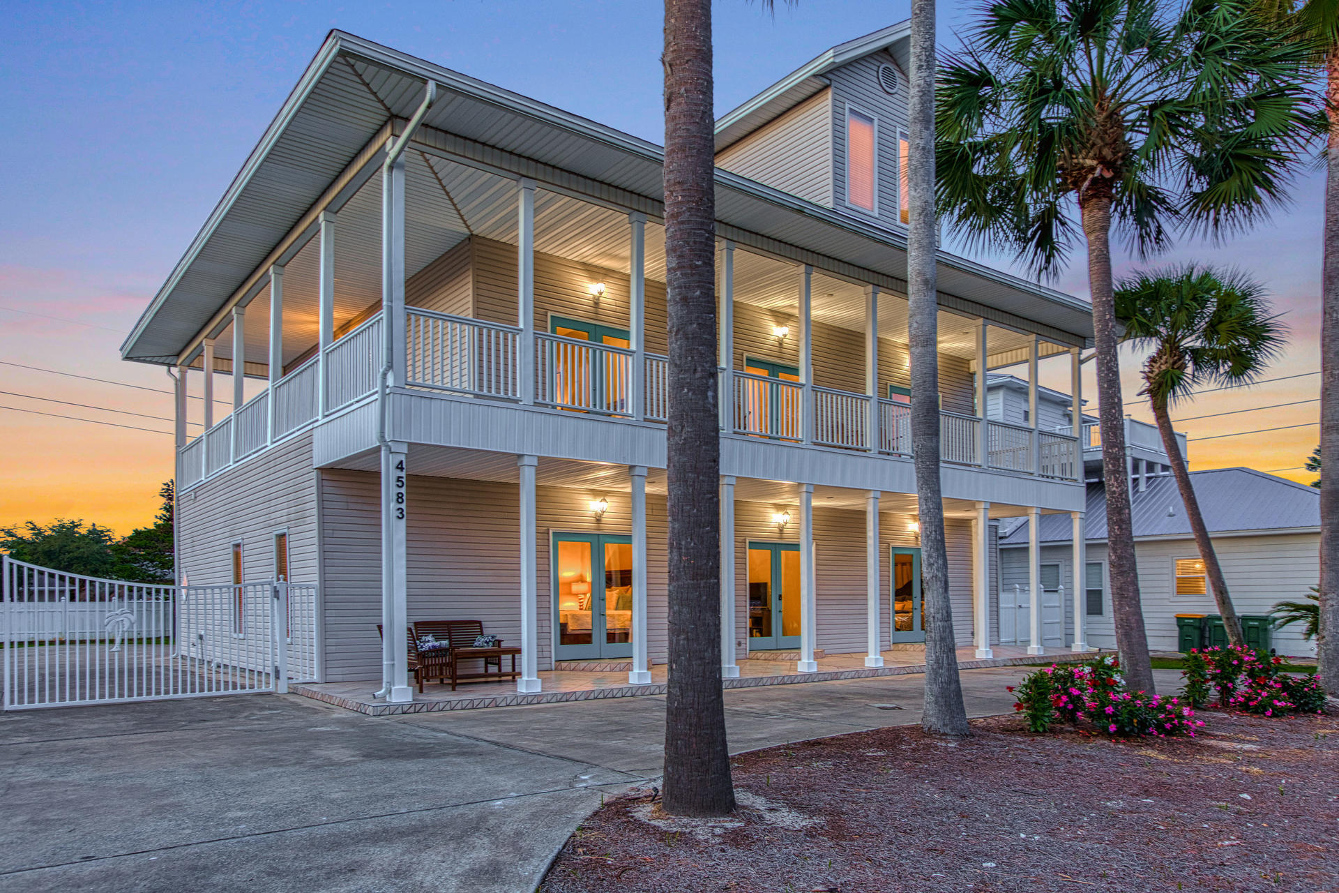 4583 Luke Avenue Destin, FL 32541 - Photo 77 of 86 a front view of a building with glass windows and plants