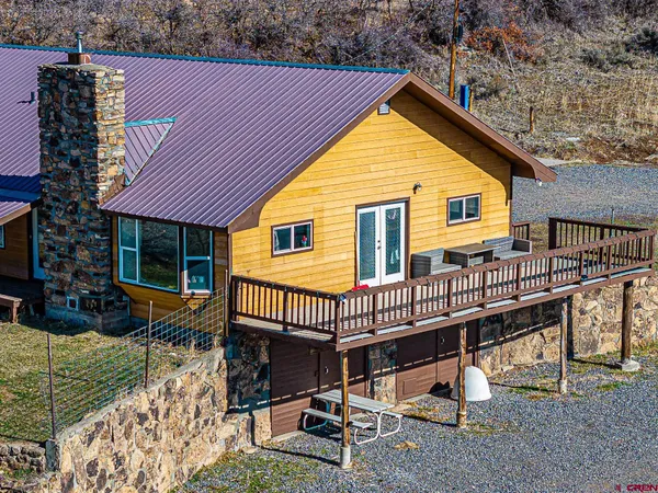 a view of a house with backyard porch and sitting area