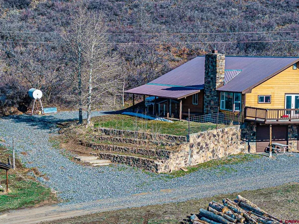 a kitchen with stainless steel appliances granite countertop a stove top oven a refrigerator cabinets and wooden floor