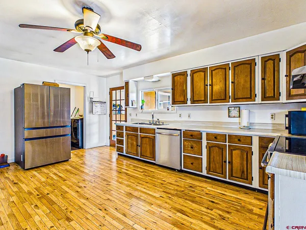 a kitchen with stainless steel appliances a stove a sink dishwasher and a refrigerator