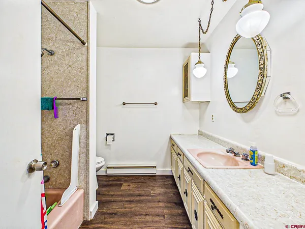 a living room with couches and painting on the wall