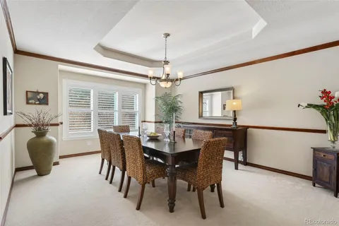 a dining room with furniture window and wooden floor