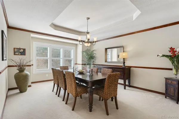 a dining room with furniture window and wooden floor