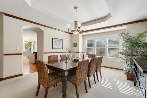 a dining room with furniture window and wooden floor