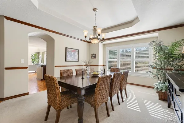 a dining room with furniture window and wooden floor