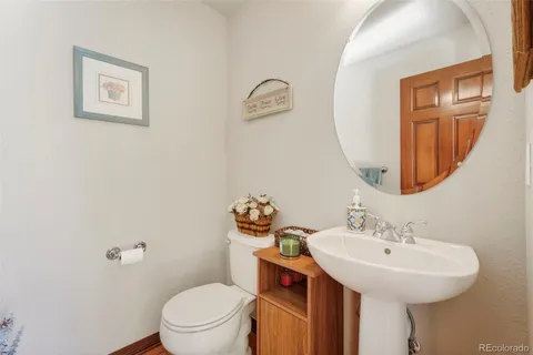 a bathroom with a toilet a sink and a mirror