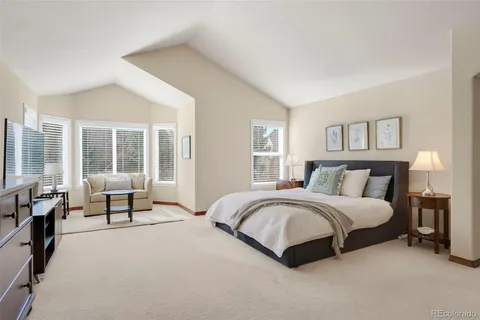 a spacious bedroom with a bed and a large window