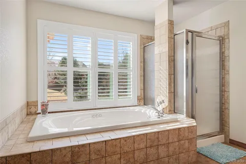 a bath tub sitting in a bathroom next to a window
