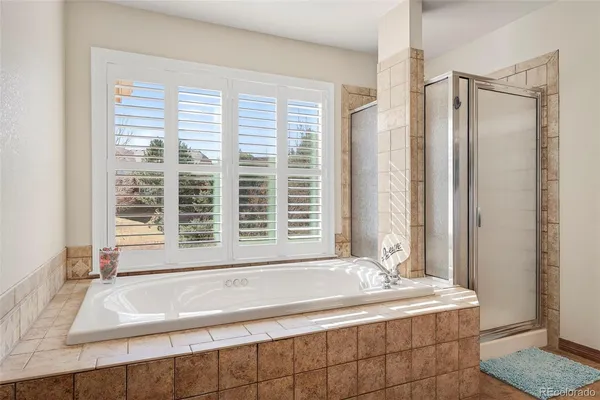 a bath tub sitting in a bathroom next to a window