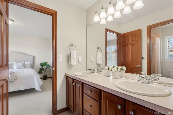 a bathroom with a double vanity sink and a mirror