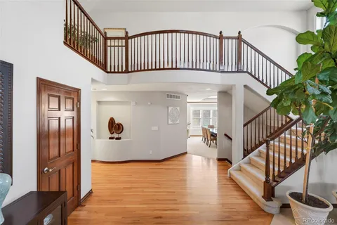 a view of entryway with wooden floor and stairs