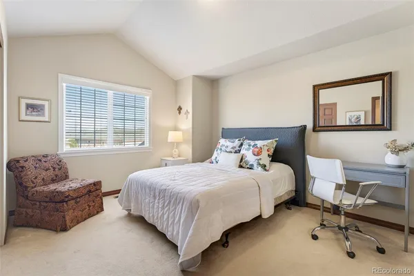 a bedroom with a bed and a couch