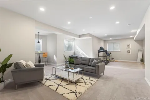 a living room with furniture and white walls