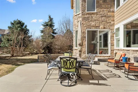a view of a patio with table and chairs and potted plants