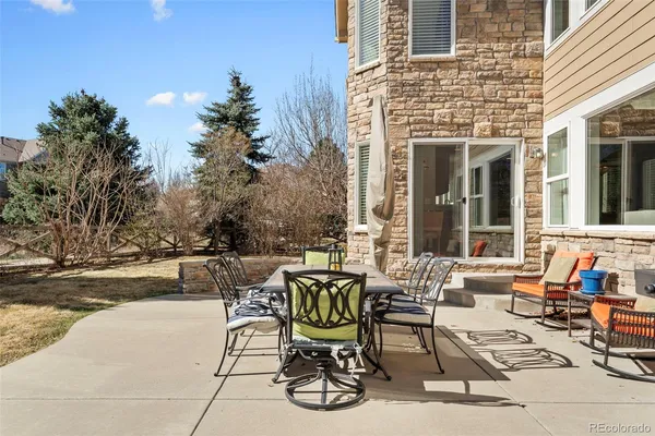 a view of a patio with table and chairs and potted plants