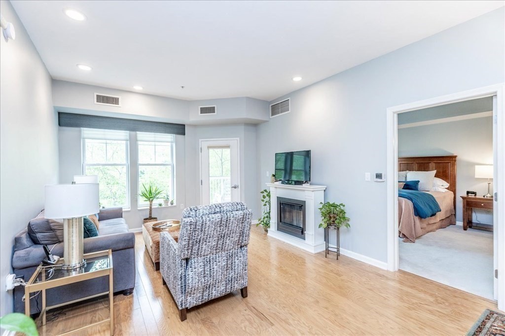 38 Village Road, Unit 312 Middleton, MA 01949 - Photo 21 of 42 a living room with furniture and a fireplace