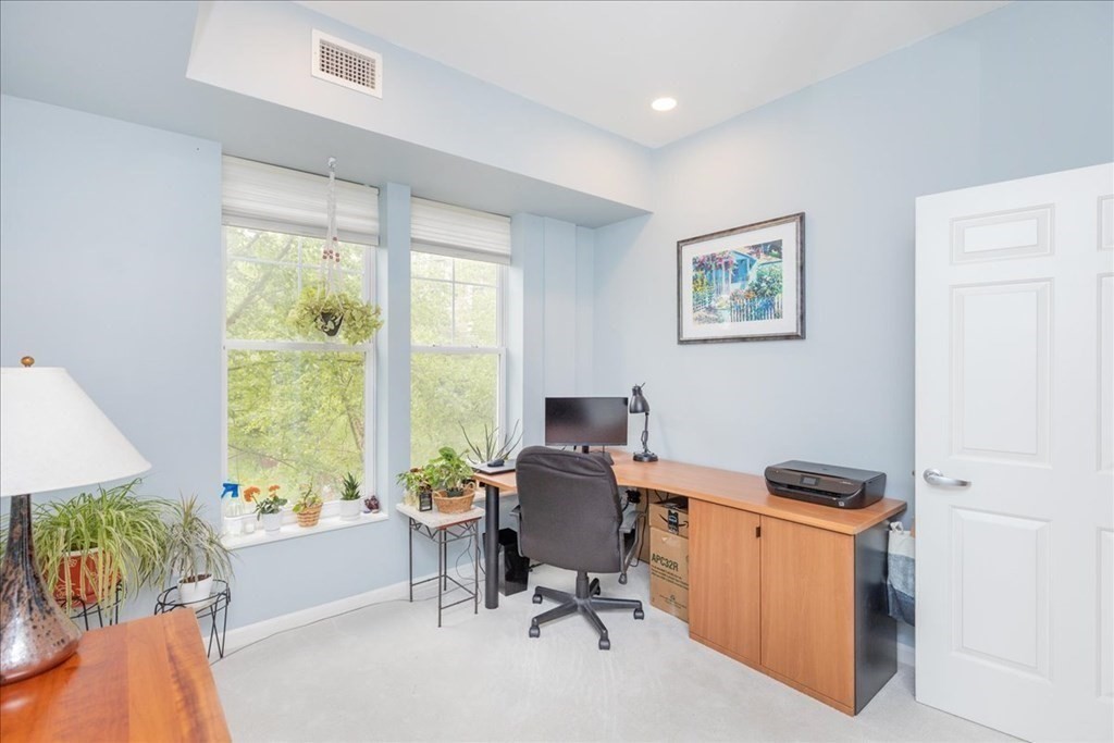 38 Village Road, Unit 312 Middleton, MA 01949 - Photo 29 of 42 a view of a workspace with furniture and a window