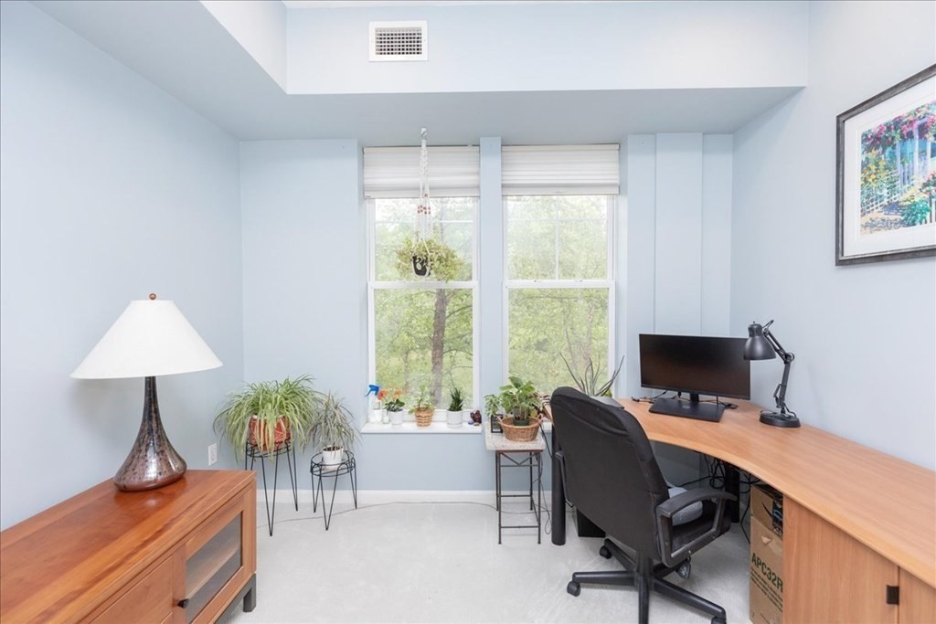 38 Village Road, Unit 312 Middleton, MA 01949 - Photo 30 of 42 a view of a workspace with furniture and a window