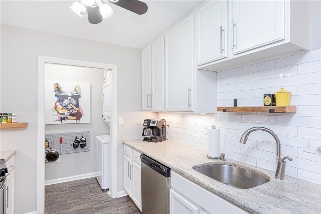 38 Village Road, Unit 312 Middleton, MA 01949 - Photo 10 of 42 a kitchen with stainless steel appliances granite countertop a sink dishwasher and cabinets with wooden floor