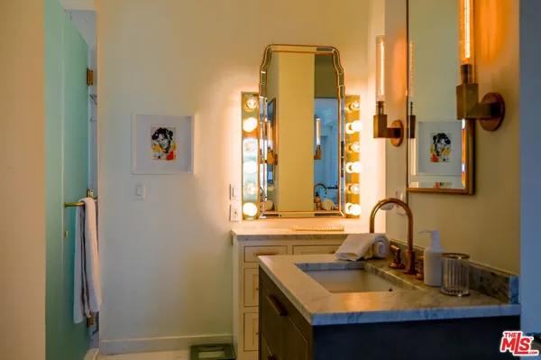 a bathroom with a sink and a mirror
