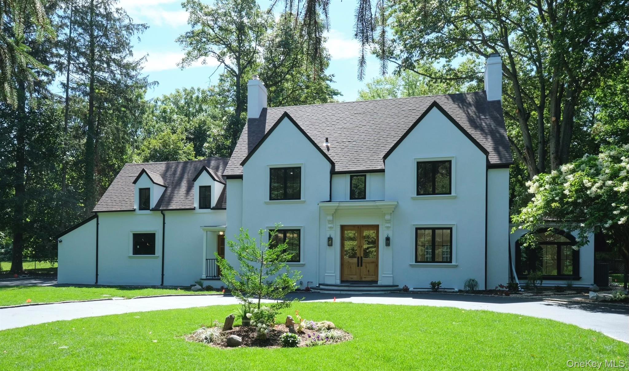 4 Harbor Acres Road Sands Point, NY 11050 - Photo 1 of 1 a front view of house with yard and green space