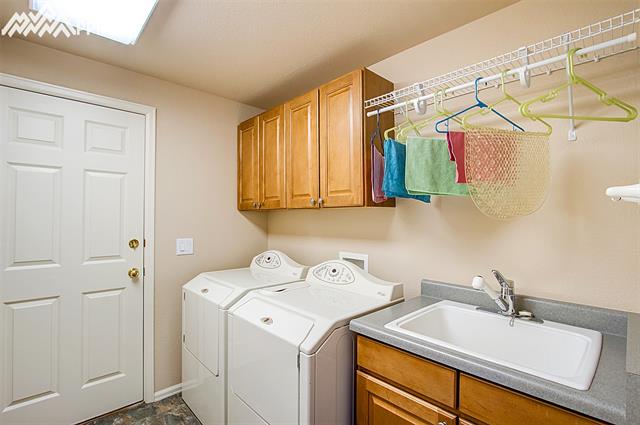 8643 Del Rio Road Peyton, CO 80831 - Photo 17 of 35 Large laundry with sink and storage.