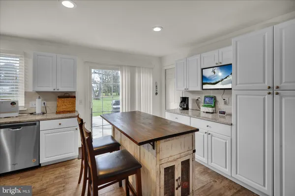 a kitchen with a table and chairs in it