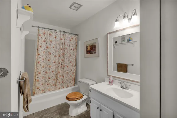 a bathroom with a sink toilet a mirror and shower