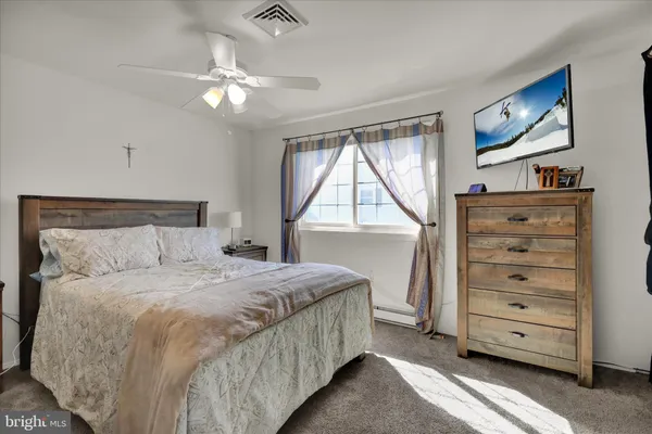 a bedroom with a bed closet and flat tv screen